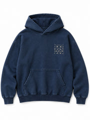 Front view of the Indigo Grid indigo sashiko stitch boxy hoodie with a small pale stitched geometric grid at the left chest