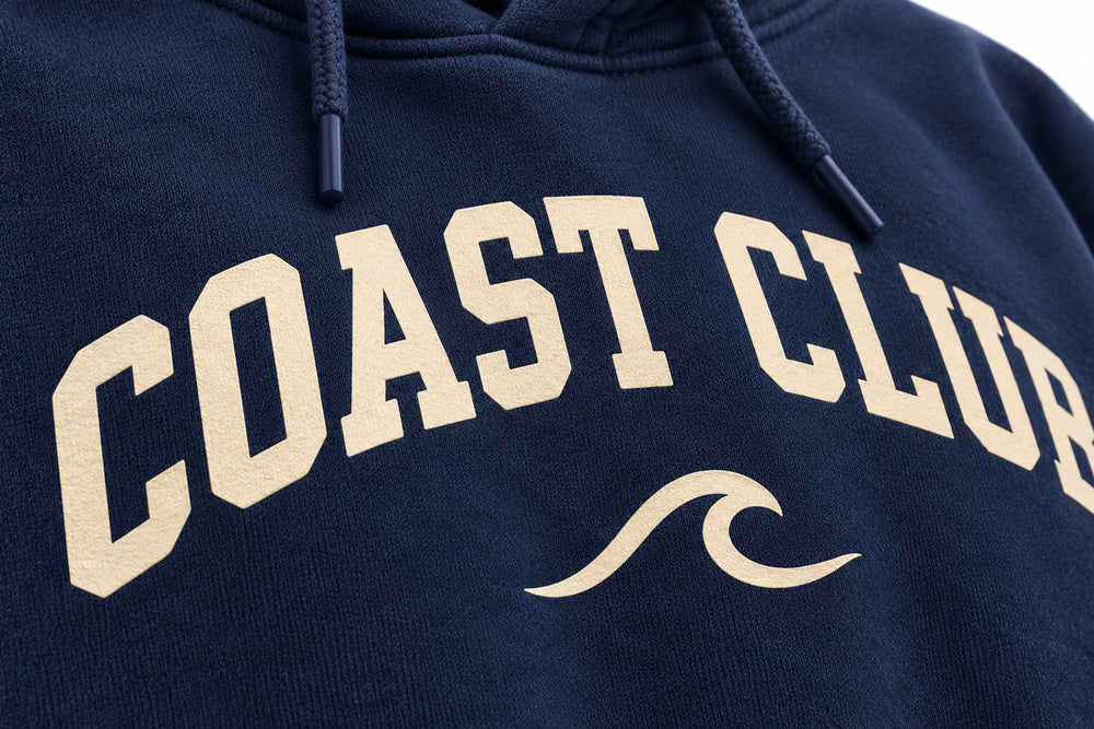 Close-up of the screen print decoration on the Coast Club navy screen print hoodie