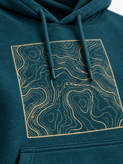 Close-up of the screen print decoration on the Topo Square deep teal screen print hoodie