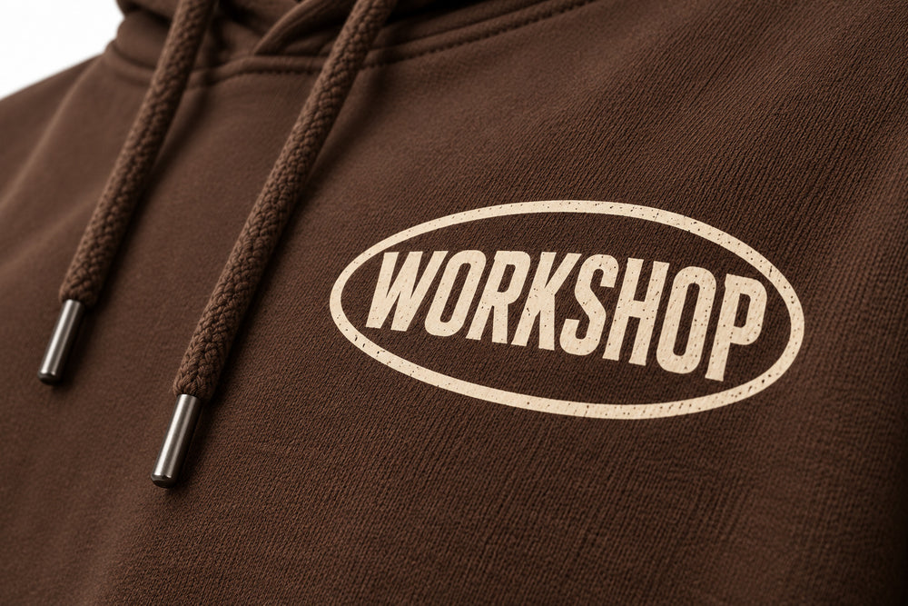 Close-up of the screen print decoration on the Workshop brown screen print hoodie