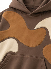 Close-up of the suede-look appliqué decoration on the Suede Shapes mocha suede-look appliqué oversized hoodie