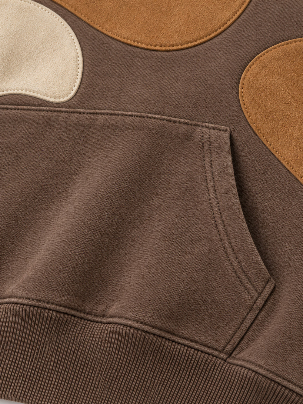 Close-up of the seam stitching of the Suede Shapes mocha suede-look appliqué oversized hoodie