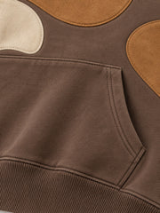 Close-up of the seam stitching of the Suede Shapes mocha suede-look appliqué oversized hoodie