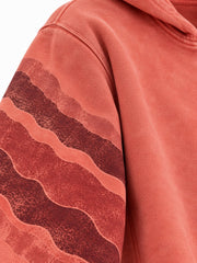 Close-up of the sun faded decoration on the Canyon Echo faded coral sun faded boxy zip-up hoodie