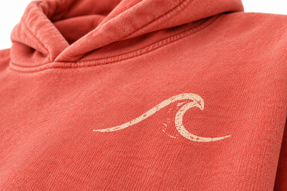Close-up of the sun faded decoration on the Coral Coast coral sun faded hoodie