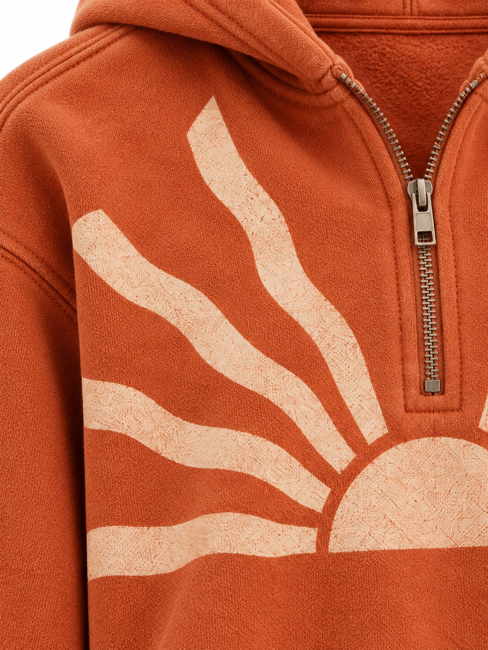 Close-up of the sun faded decoration on the Solar Trace burnt orange sun faded cropped half-zip hoodie