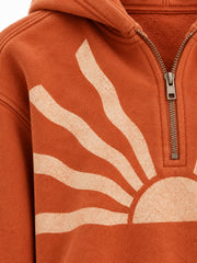 Close-up of the sun faded decoration on the Solar Trace burnt orange sun faded cropped half-zip hoodie