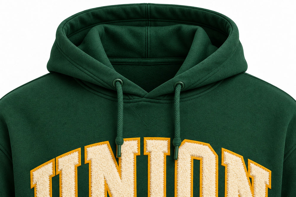 Close-up of the hood and neckline of the Athletic Union forest green twill appliqué hoodie