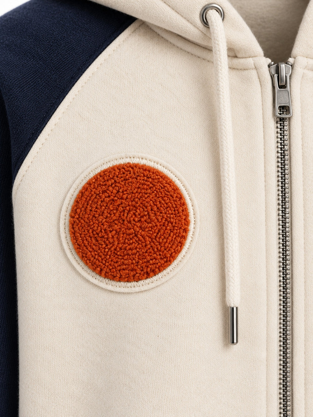 Close-up of the chenille decoration on the Sun Sprig cream and navy chenille zip-up hoodie